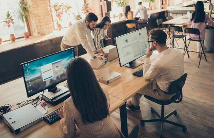 Focused skilled people analyzing finance potential result investment money capital at modern industrial loft brick open space style interior workplace workstation